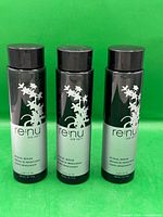 Three bottles standing upright front view