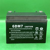Front view showing 6DM7 label and caution text