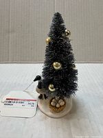 Front view of figurine showing tree, goose and nest