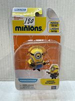 Front view of sealed Minion Stuart figure in original packaging showing figure and guitar