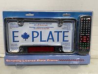 Front of sealed retail package showing license plate frame and remote