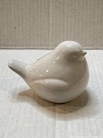 front view of white ceramic bird figurine