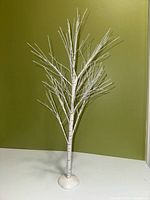 Front view of white birch tree figurine on base