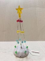 Full view of Department 56 lit pole tree showing star, bead tiers, base