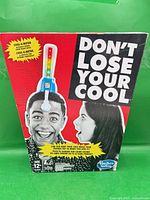 Front of boxed Hasbro 'Don't Lose Your Cool' game showing branding, Cool-O-Meter image, age rating 12+