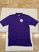 Full view of purple Tri-Mountain polo shirt