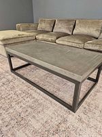 Coffee table front view beside sectional sofa
