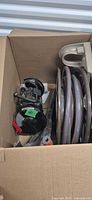 Box with Gardena hose and additional view of grinder accessories