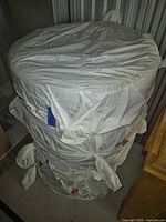 Stack of four wheel/tire assemblies bagged for storage