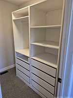 Full view of two-column white PAX organizer in closet alcove