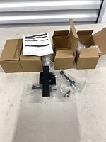 Four small boxes, instruction sheet, handles and hardware in plastic