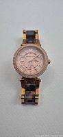 Front view of Michael Kors rose-gold dial watch with tortoiseshell bracelet