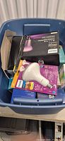 Bin containing Philips 65W LED bulb in blister, Hue kit box, other boxed Philips lighting