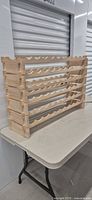 Full view of assembled modular wooden wine rack on table