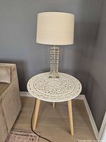 Lamp on round table showing full height with shade