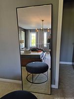 Front view of full-length mirror leaning against wall