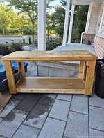 Full view of wooden workbench with lower shelf and casters