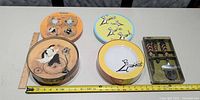 Overall view of two plate tins and packaged cheese set with measuring tapes showing scale