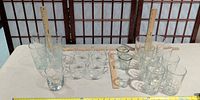 All 22 clear glass pieces arranged on table with rulers for scale