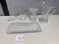 All five clear pressed glass pieces grouped