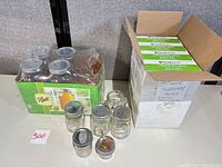 Overall view showing boxed half-gallon jars, FoodSaver roll boxes, and loose small jars