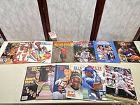 All 13 magazines laid out showing mix of basketball, baseball, hockey covers