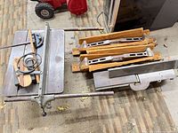 Bench-top assembly, fence, belts, pulleys, miter gauge, saw horse beams visible