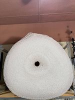 Front view of large clear bubble wrap roll on shelving