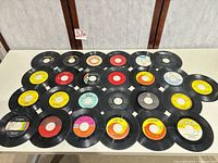 Overview of all roughly 25 singles laid out on table