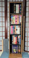Front view showing media shelf filled with VHS tapes