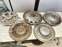 All five hubcaps laid out on table