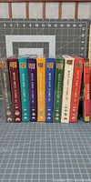 Spine view showing all nine season box sets standing upright