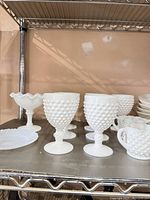 Group of hobnail goblets, compote and other pieces on shelf