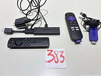 Overview of both streaming sticks, remotes, cables, adapter and lot number