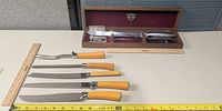 All eight utensils arranged with rulers for scale, Gerber case open