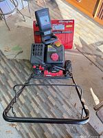 Front view of MTD snow blower with handlebar, controls and chute