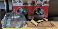 Boxed Bundt baking set with cake keeper dome, Bundt pan visible, pastry rollers and cabin mold