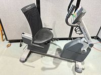 Left side view of grey NordicTrack SL728 recumbent bike showing seat, frame, and pedals
