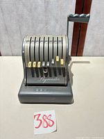 Front view showing Paymaster adding machine, keys and logo