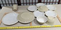 Group shot showing all plates, bowls and mug with measuring tape for scale