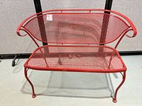 Front view of red steel mesh loveseat bench