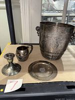 Overview of all four silver-plated pieces on table