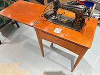 Singer sewing machine in wooden cabinet, top view