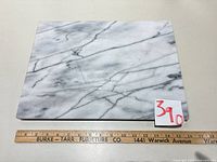 Top view of rectangular marble board showing veining pattern and ruler for scale