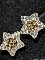 Front view of star-shaped CZ stud earrings
