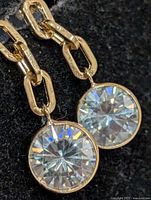 Front view of both earrings showing moissanite stones and gold link drops