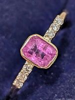 Ring front view showing pink sapphire and diamond shoulders