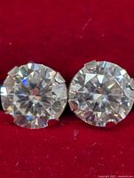 Front view of both moissanite studs in red box
