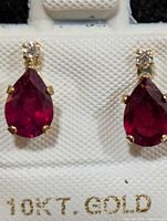 Front view of both earrings showing ruby and moissanite stones
