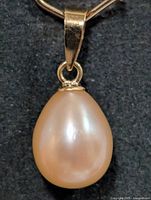 Front view of teardrop pearl pendant showing lustre